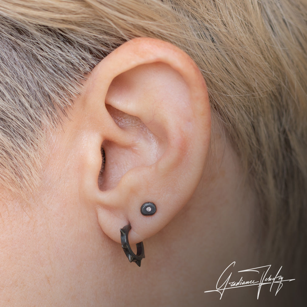 Gradiance Jewelry women's oxidized silver small spike Moto hoop earrings from the "Little Black Jewelry" collection - model shot.