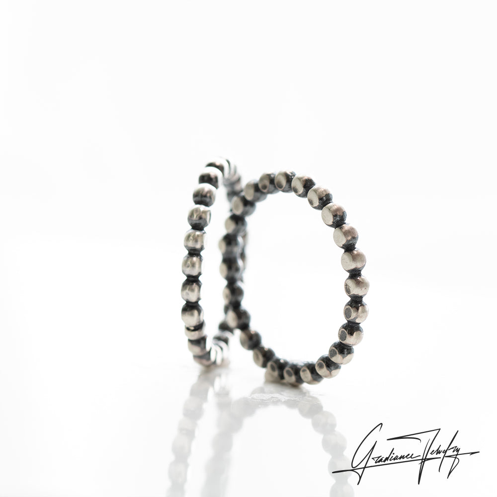Gradiance Jewelry women's oxidized silver flat beaded Spoked Out stacker band from the Little Black Jewelry Collection - side view.