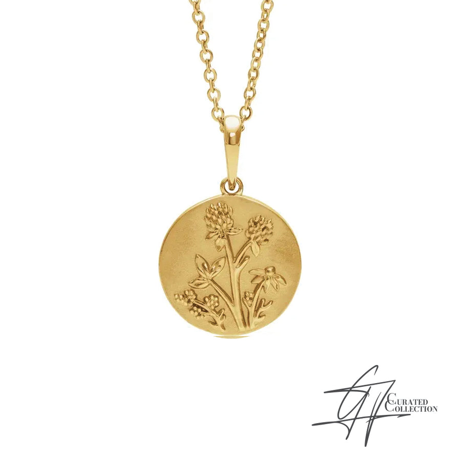 GJ Collection 14KT Yellow Gold women's Wild Necklace featuring a circular gold medallion with wildflowers on the front.