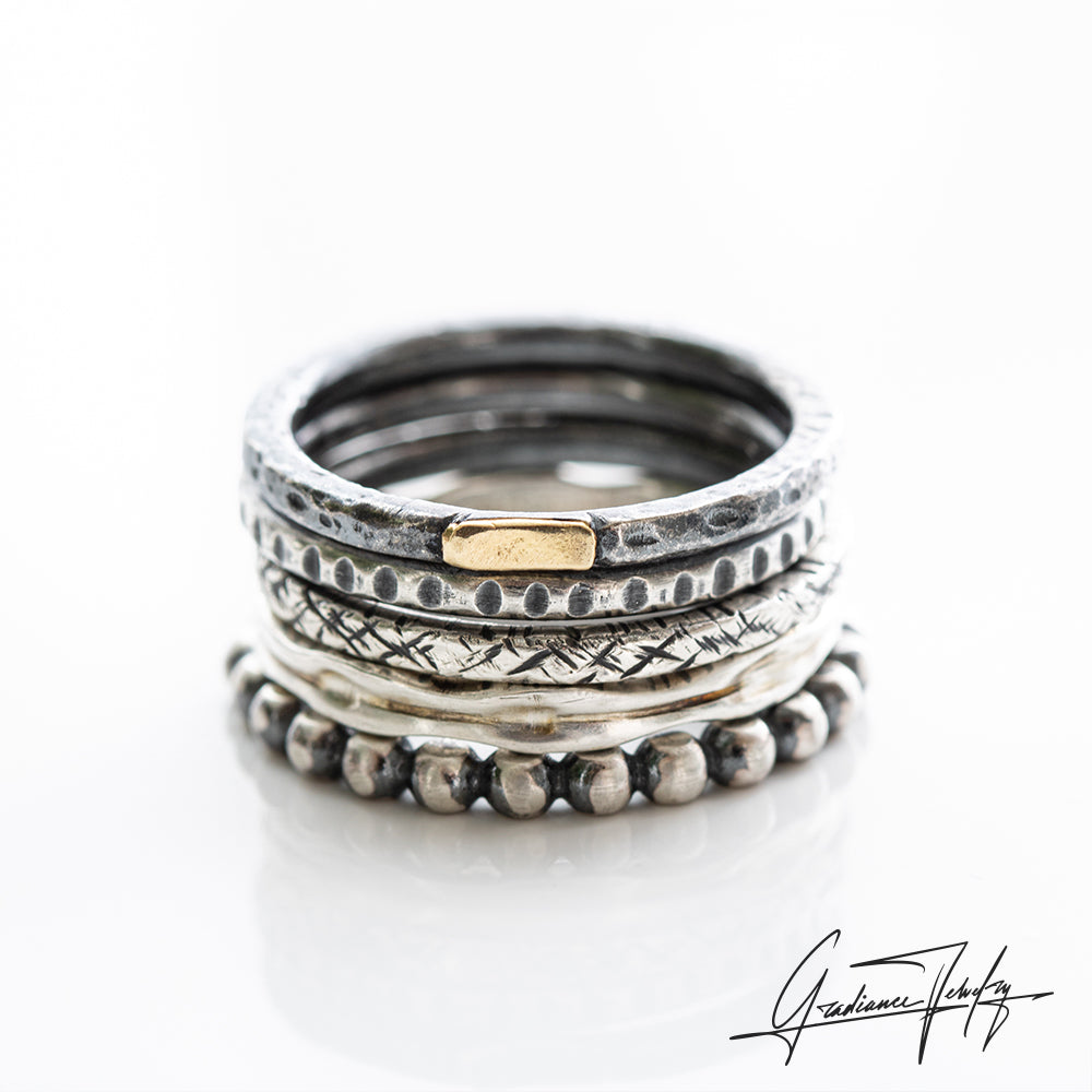 Gradiance Jewelry oxidized silver and 18KT yellow gold Mega Stacker bands from the Little Black Jewelry Collection.