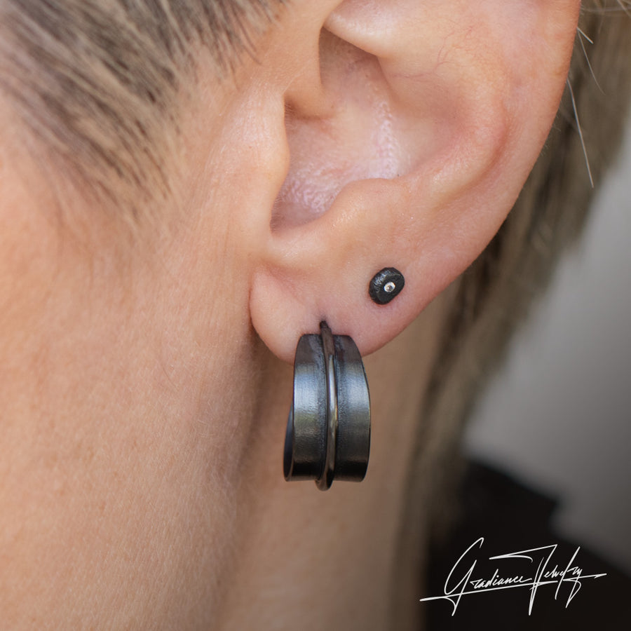 Gradiance Jewelry women's oxidized silver wide Statement Hoops from the Little Black Jewelry Collection - close up shown on model.