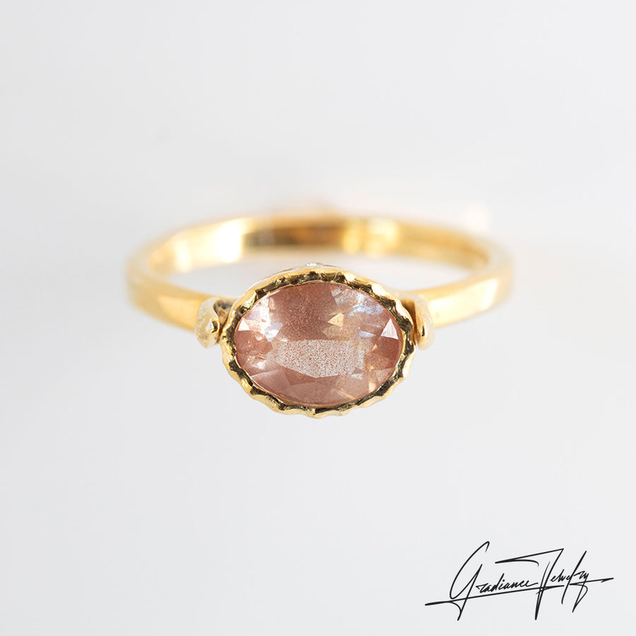 Gradiance Jewelry Sun Chaser Collection: women's 14KT yellow gold Rose ring featuring an oval Oregon Sunstone with schiller effect, accented by two diamonds and a leaf design, product shot.